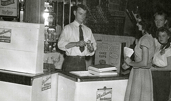Old photo of man scooping an ice cream cone